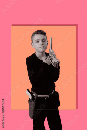 Gunslinger. Playful portrait of a young boy dressed as a cowboy, posing confidently in a themed costume with toy guns. Fun, humorous children’s character for editorial, advertising, graphic resources