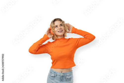 Young woman with curly hair and smile, hands near head, PNG