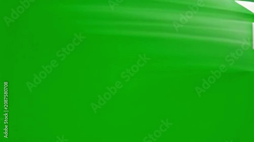 Closeup of White Paper Airplane Flying Against Bright Green Background