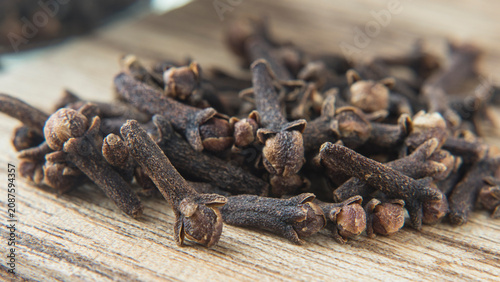 A habdfull of cloves on a cutting board . Background image . 