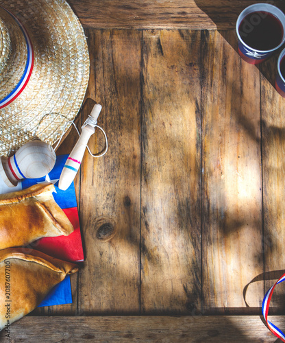 Chilean independence day concept. fiestas patrias. Tipical baked empanadas, fat and play emboque. Decoration for 18 september party day, wooden background