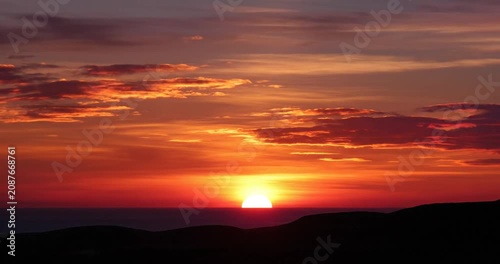 Sunset over mountain range landscape.