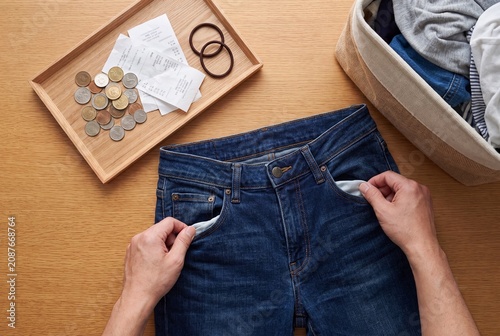Person Checking Empty Pockets of Blue Jeans Before Laundry