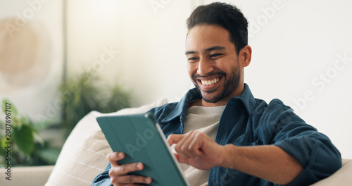 Streaming, digital or man on couch with tablet, video subscription or post update on online site. Happy, relax or person in house with tech, internet search or show binge on entertainment platform.