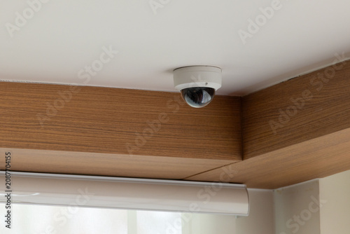 Ceiling-mounted security camera in modern room