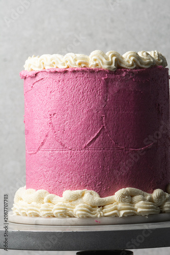 pink and cream vintage style cake on a dessert stand, trending hot pink vintage buttercream cake on a white background, process of decorating a buttercream cake