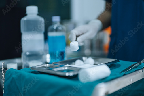 Obraz na plátně Healthcare Worker Holding Sterile Cotton with Forceps During Clinical Wound Care