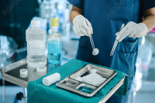 Photos Healthcare Worker Handling Sterile Cotton with Forceps During Wound Dressing Pro