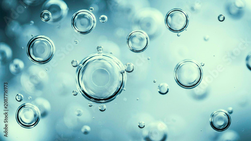 Macro shot of clean blue water bubbles floating with soft bokeh background