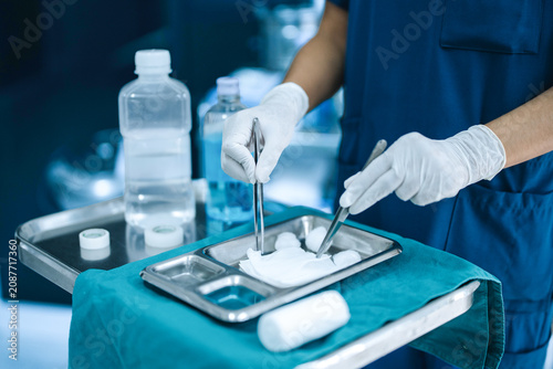 Photos Medical Staff Preparing Sterile Gauze with Forceps Before Clinical Procedure
