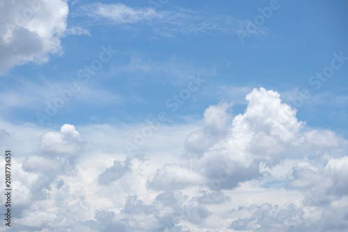 Bild auf Leinwand fluffy white clouds building up in the light blue sky