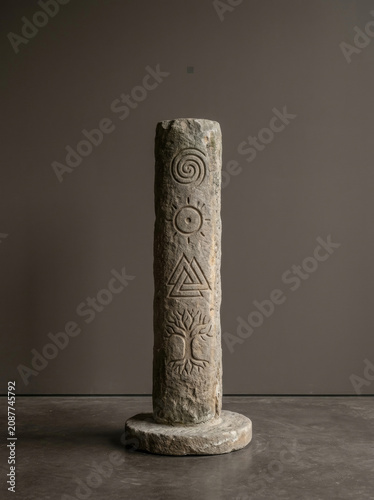 An ancient stone stele engraved with pictographic symbols