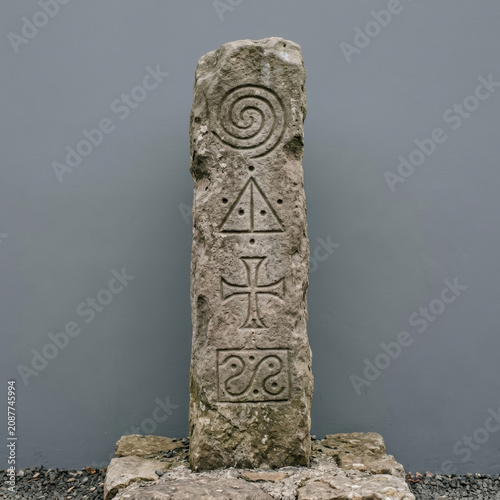 An ancient stone stele engraved with pictographic symbols