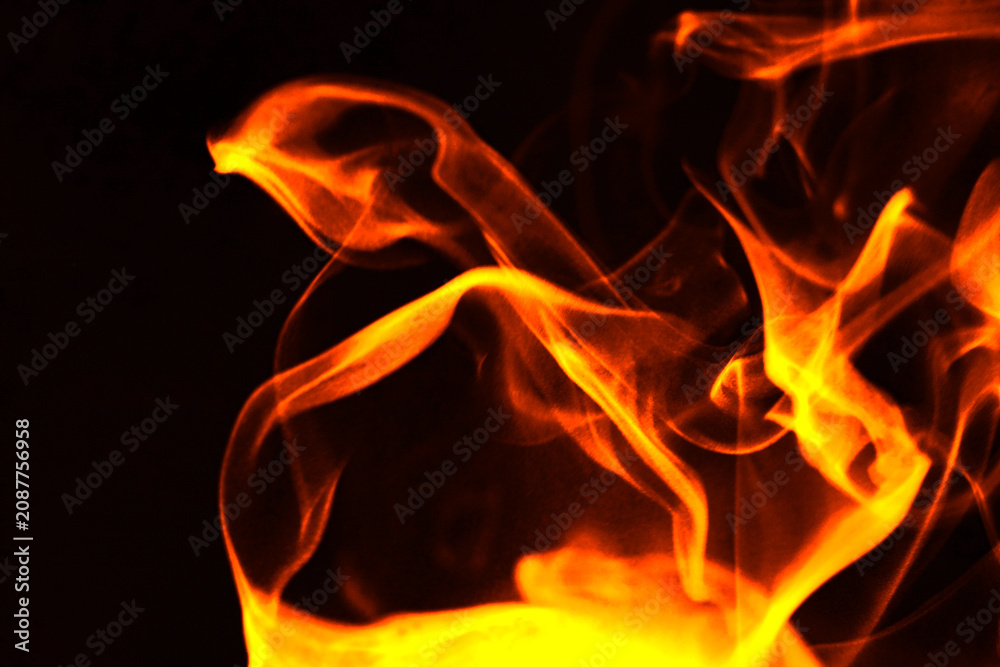 Fototapeta premium Abstract burning fire flames and smoke texture on black background