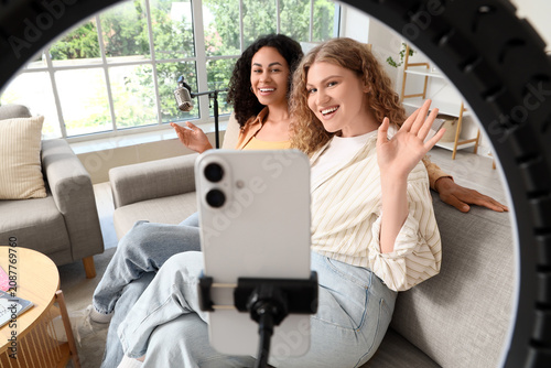 Two young women recording v...
