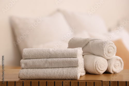 Clean towels on shelf in be...