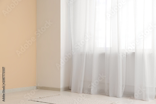 Modern curtains hanging on ...