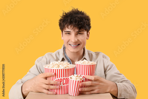 Young man with popcorn buck...