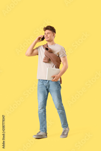 Young man talking by mobile...