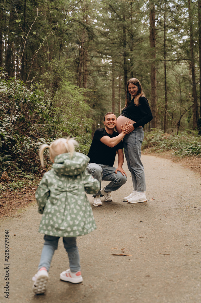 Fototapeta premium Parents with their child in the forest