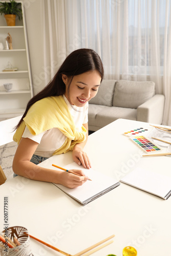 Female Asian artist drawing...