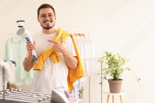 Happy young man pointing at...