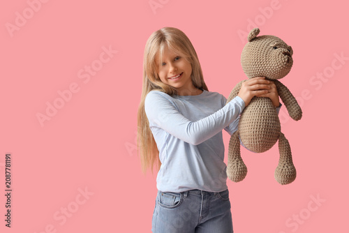 Cute little girl with plush...