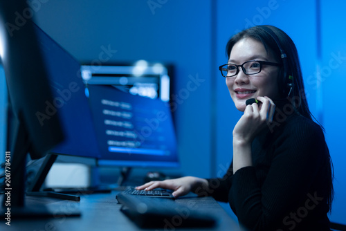 Customer service, asian female IT support engineer wearing headset working on computer code, technical helpdesk, call center, software development, cybersecurity and global corporate communications