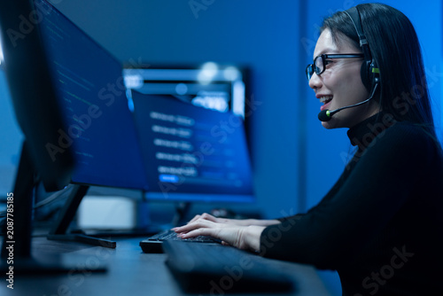 Customer service, asian female IT support engineer wearing headset working on computer code, technical helpdesk, call center, software development, cybersecurity and global corporate communications
