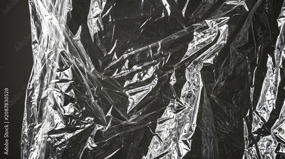 Fototapeta premium Heavy crinkled clear plastic sheet texture with high contrast reflections