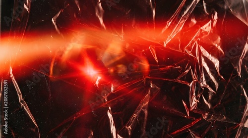 Light leak overlay with dramatic red flare on vintage crinkled cellophane