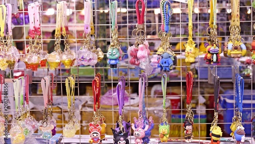Foto Colorful Cartoon Character Keychains Hanging on Display Rack at a Local Vietname