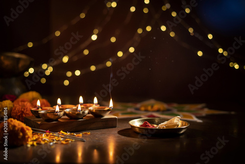 Traditional Diwali oil lamps with golden bokeh background, glowing diya oil lamps for Hindu festival of lights, spiritual puja ceremony setting