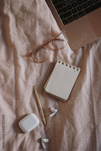 Minimalist home office essentials placed on soft fabric