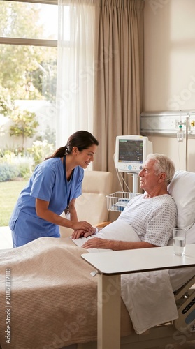 Nurse Provides Compassionate Support to Senior Patient in Hospital Bed Fostering Trust and Empathy