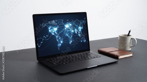 A professional workspace featuring a sleek black laptop displaying a glowing digital world map on its screen next to a small brown notebook and a ceramic mug on a minimalist dark office desk surface