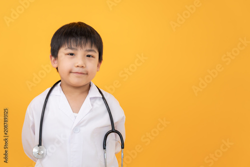 Картината върху платно Young cute Asian boy playing doctor