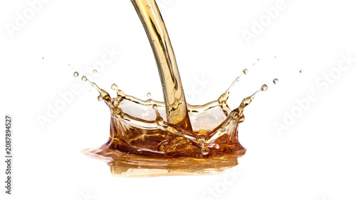 Golden liquid pouring into a pool creating a circular crown splash with tiny droplets flying outwards, isolated on a solid black background