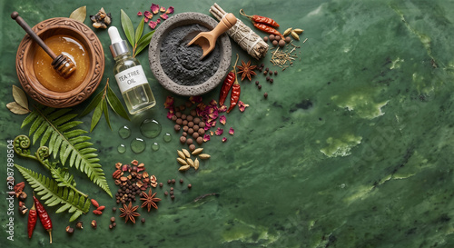 Top down view of New Zealand Manuka honey and mud spa ingredients on jade stone