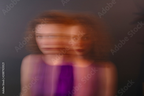 Portrait of red-haired woman, blurred, double