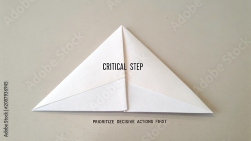 White Paper Triangle Origami with Text Emphasizing Importance of Prioritizing Decisive Actions in Critical Steps