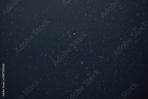 Water spots on window, with two droplets in centre