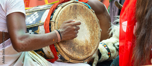фотографія Musician Playing Traditional Hand Drum at Vibrant Indian Festival Celebration