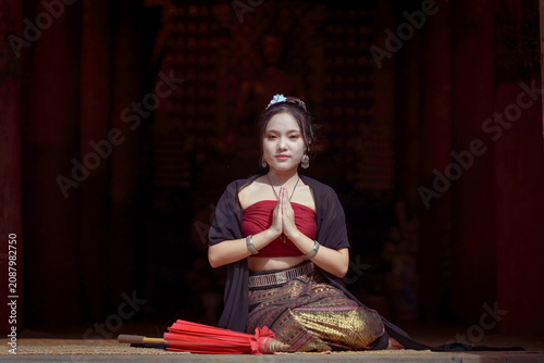 Beautiful Asian Woman in Traditional Lanna Costume at Wat Ton Kwen Ancient Wooden Temple, Chiang Mai, Thailand