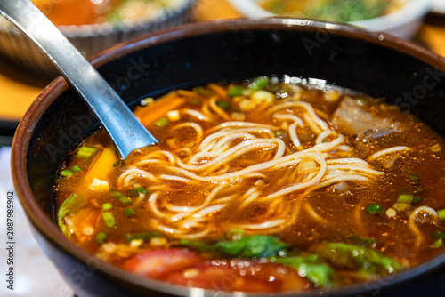 A close-up of classic traditional beef noodle soup and its rich broth.
