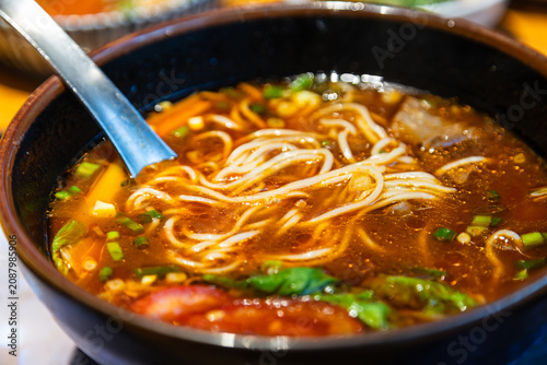 A close-up of classic traditional beef noodle soup and its rich broth.