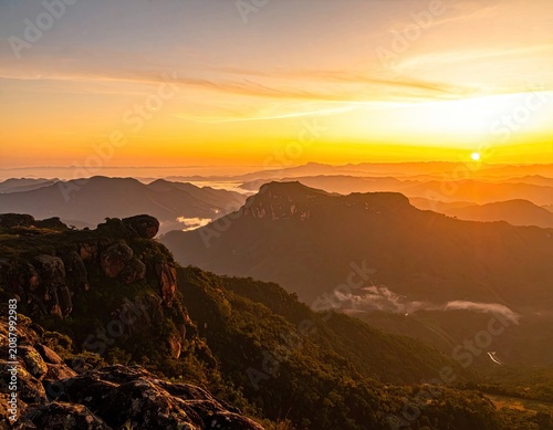 Majestic mountain range bathed in the warm glow of a golden sunrise.