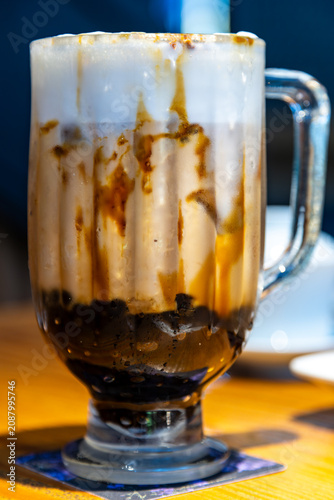 A close-up of classic brown sugar bubble tea with images of a crystal-clear, chilled drink in a glass.
