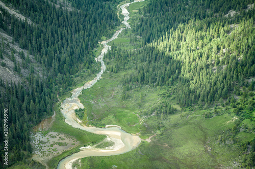 Aerial Close-up of Meandering Rivers and Coniferous Forest on Genyen South Route