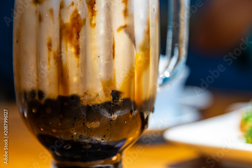 A close-up of classic brown sugar bubble tea with images of a crystal-clear, chilled drink in a glass.